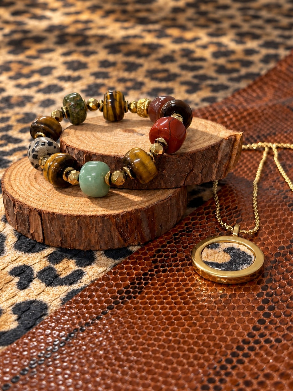 Center Stage necklace styled alongside a beaded bracelet on wood displays