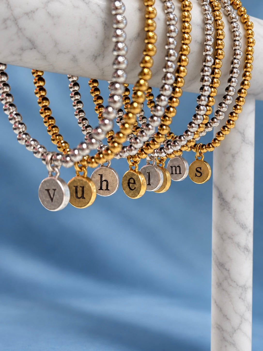 Gold and silver initial pendant bracelets