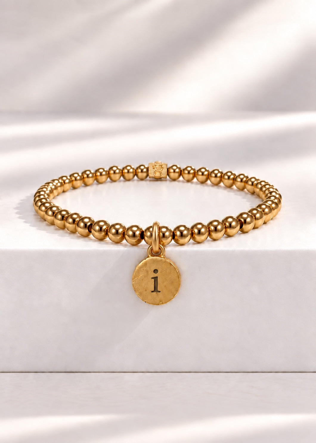 Gold stainless steel beaded bracelet with I initial pendant