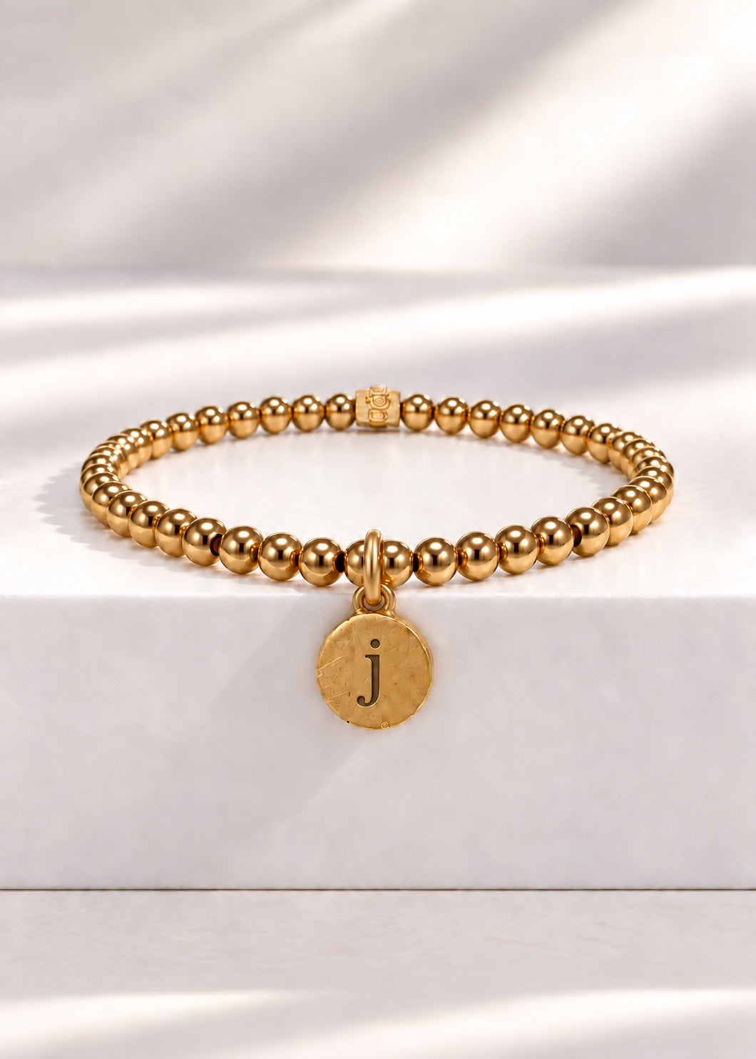 Gold stainless steel beaded bracelet with J initial pendant