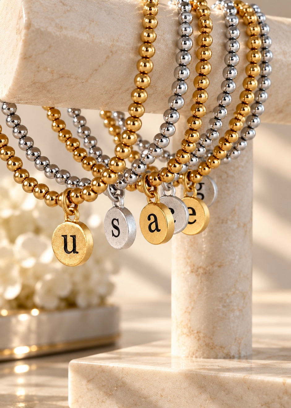 Initial pendant bracelets in gold and silver on jewelry display