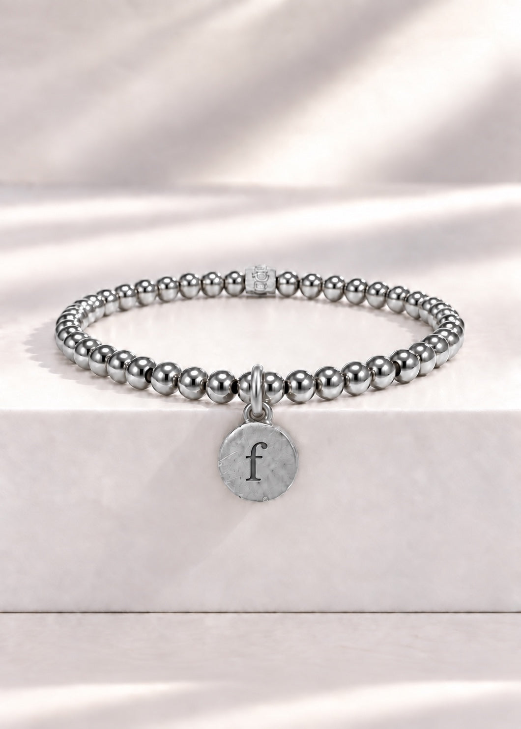 Silver stainless steel beaded bracelet with F initial pendant