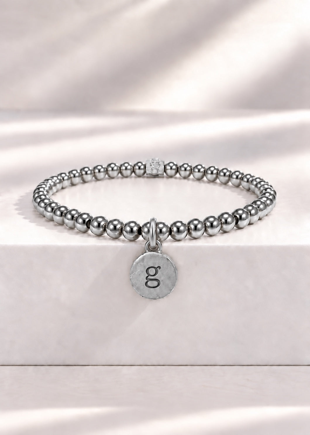 Silver stainless steel beaded bracelet with G initial pendant