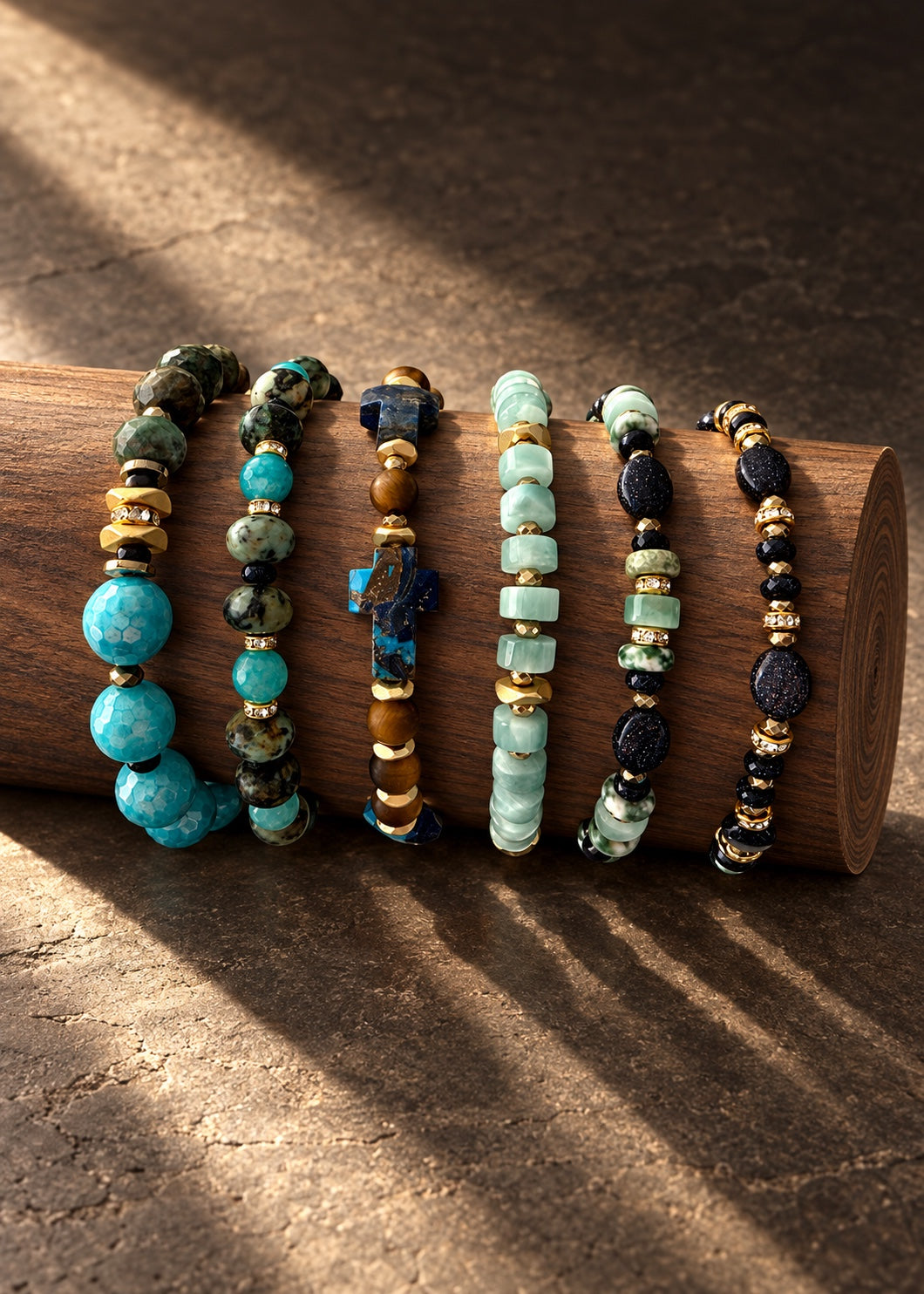 All six Woodland Blue beaded bracelets displayed together on a wooden cylinder