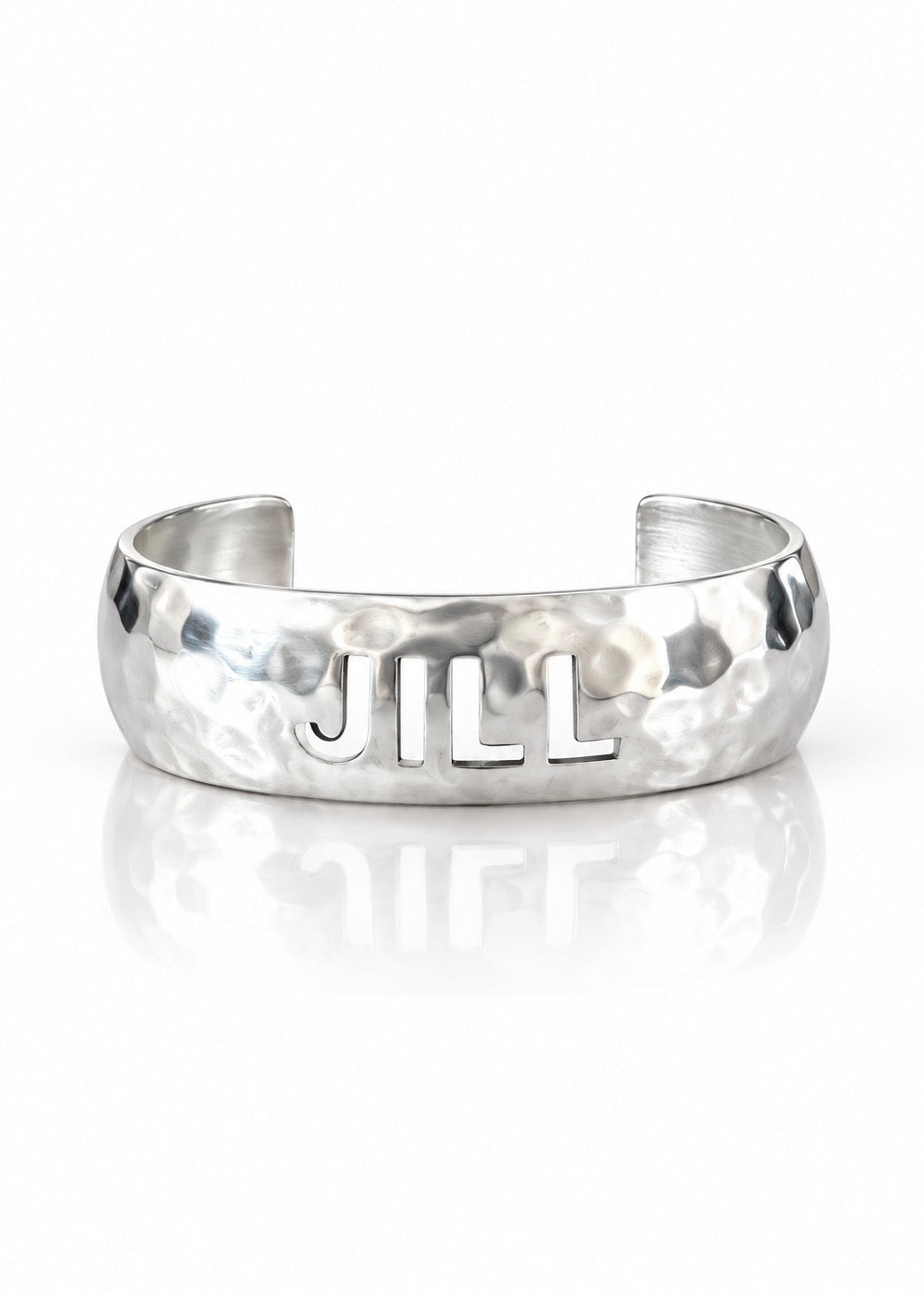 Domed silver cut-out name cuff, front view with Jill example