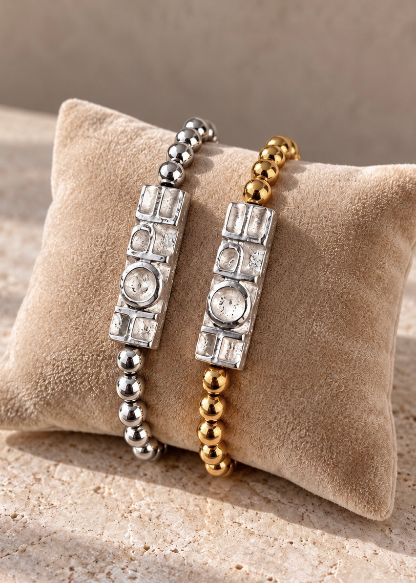 Gold and silver Hope bracelets styled together