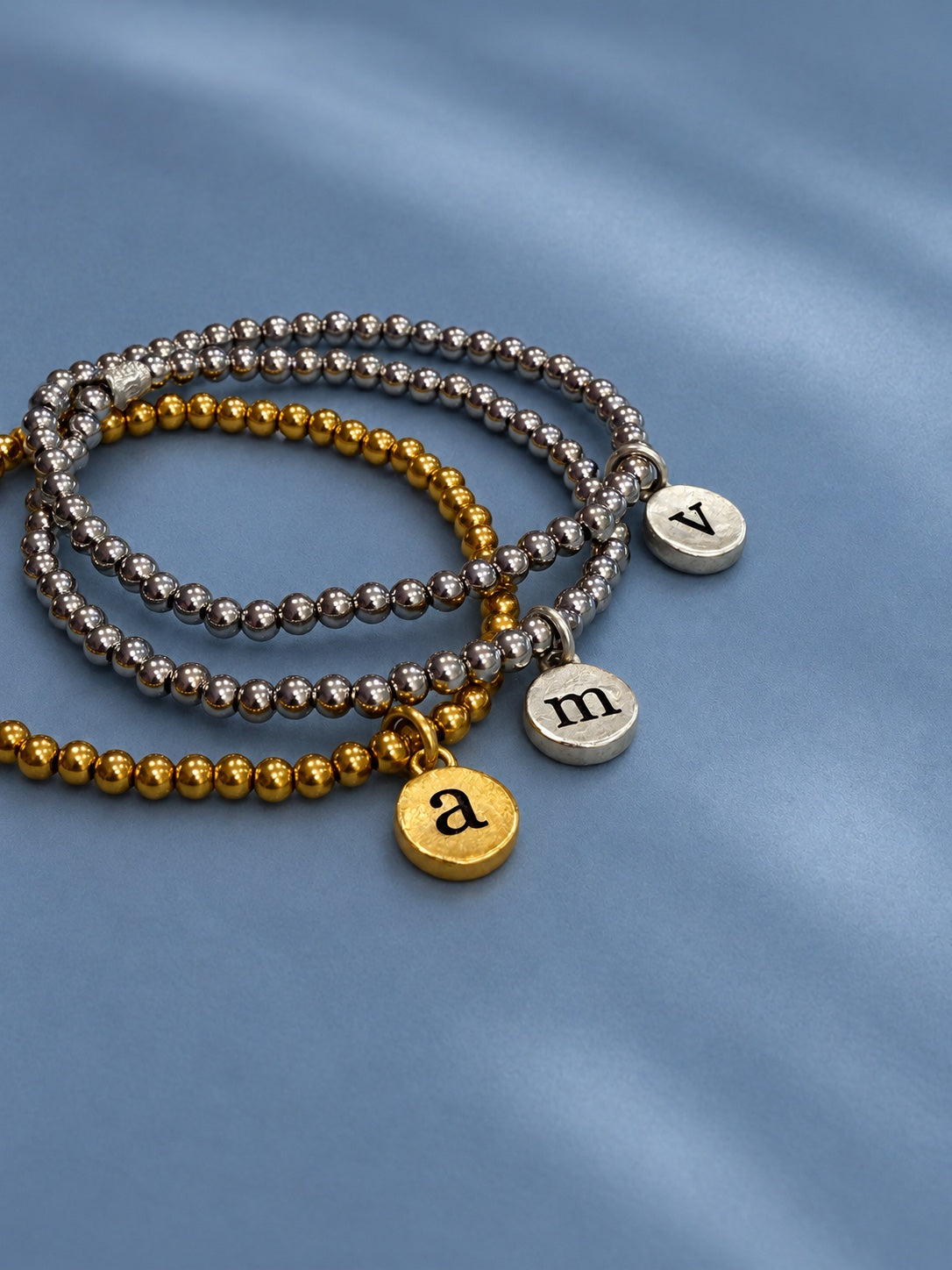 Gold and silver initial pendant bracelets