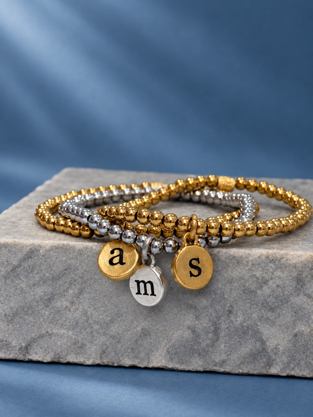 Gold and silver initial pendant bracelets