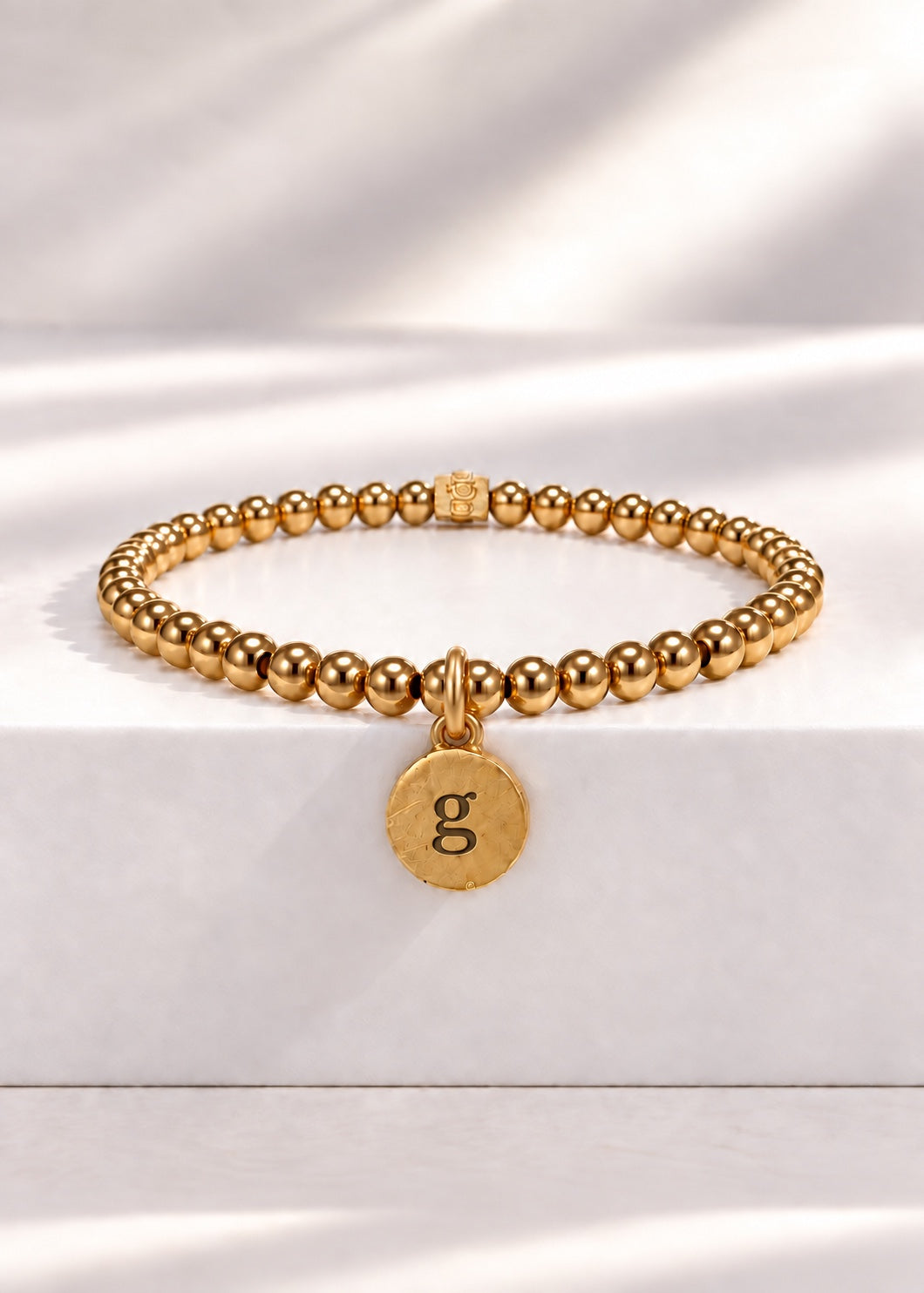 Gold stainless steel beaded bracelet with G initial pendant