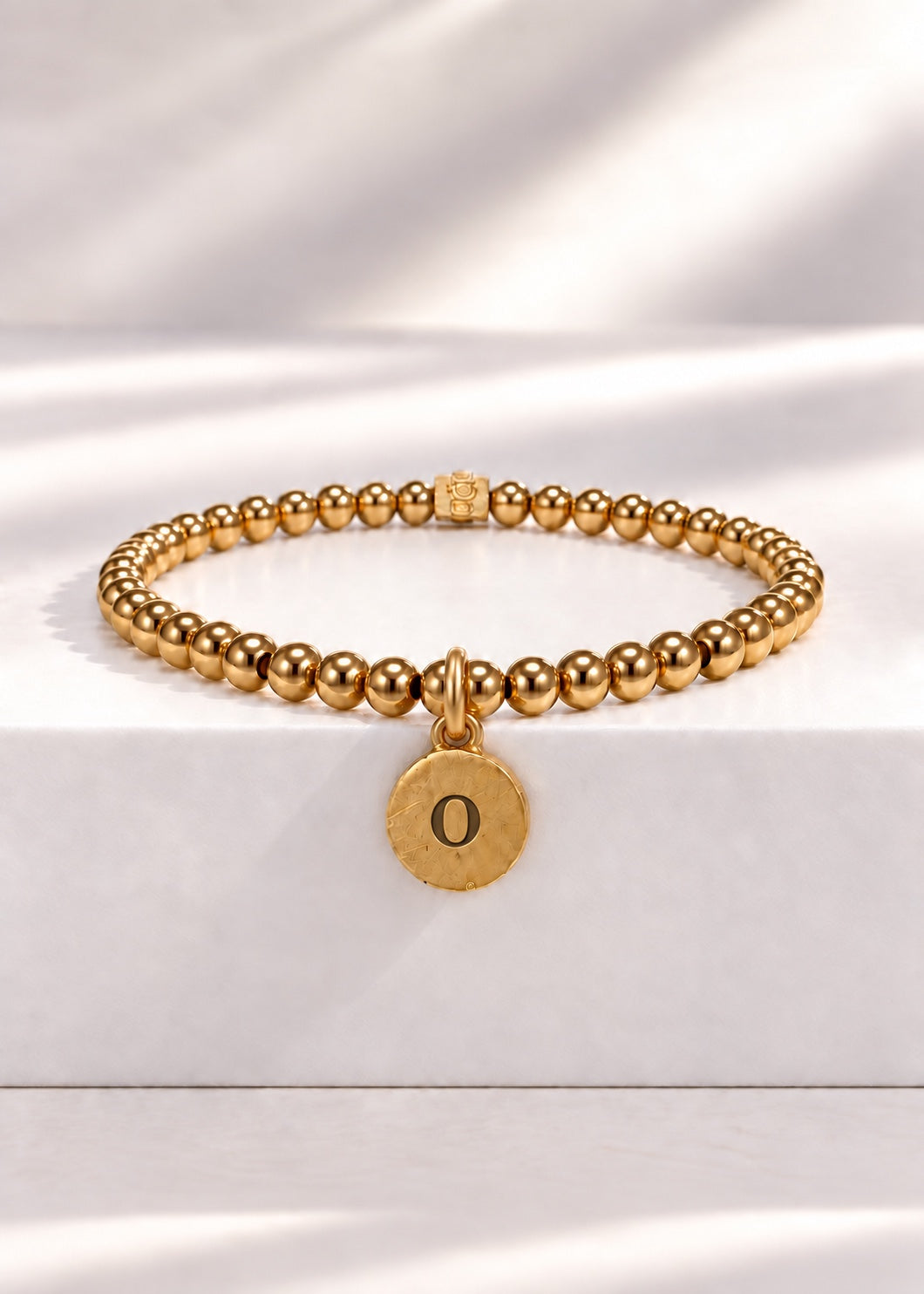 Gold stainless steel beaded bracelet with O initial pendant