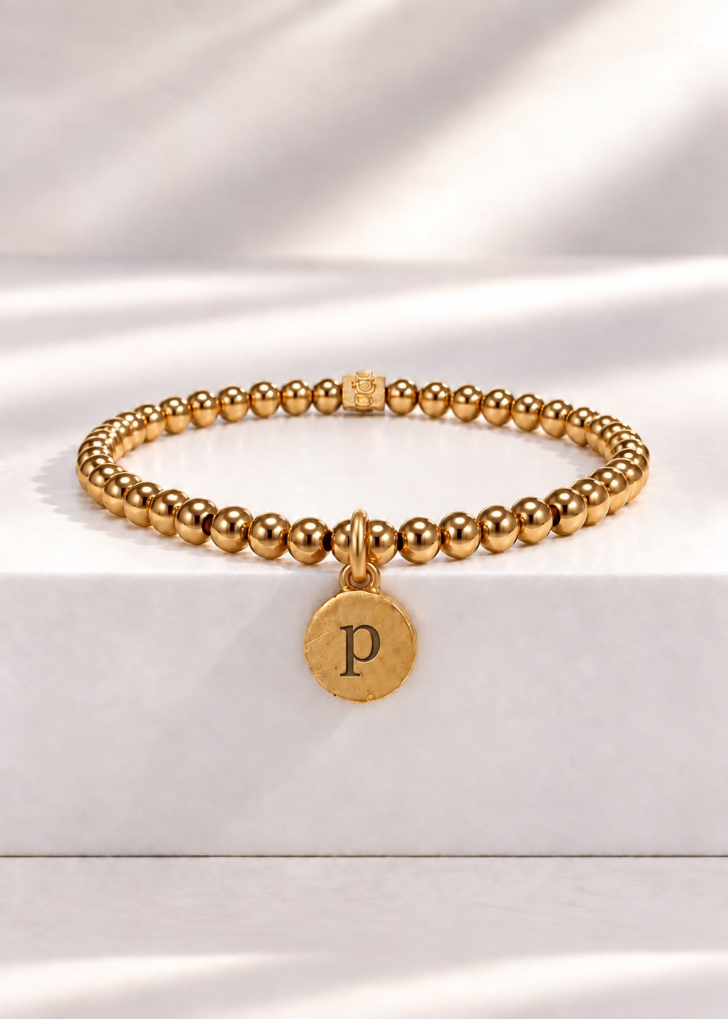Gold stainless steel beaded bracelet with P initial pendant