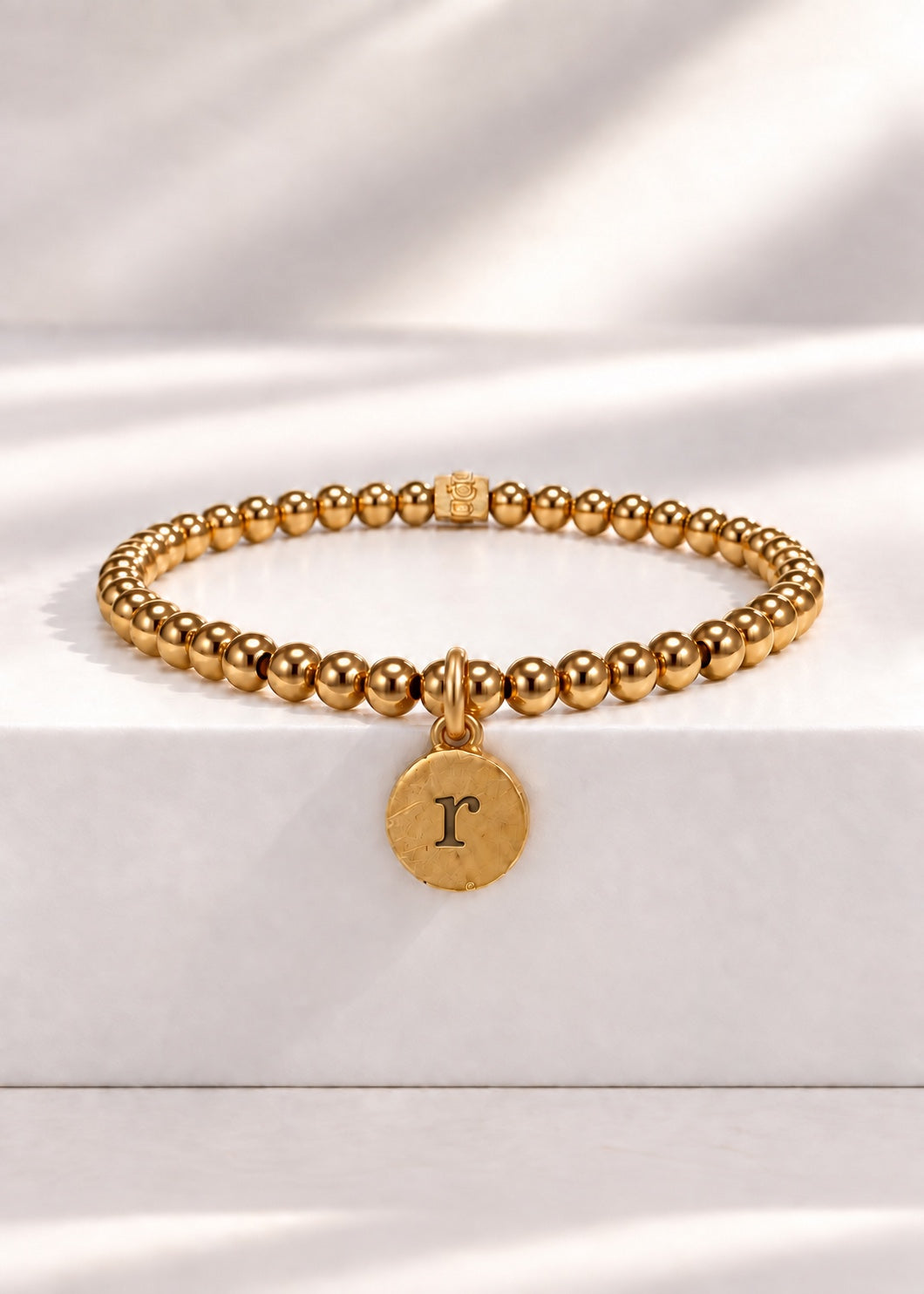 Gold stainless steel beaded bracelet with R initial pendant