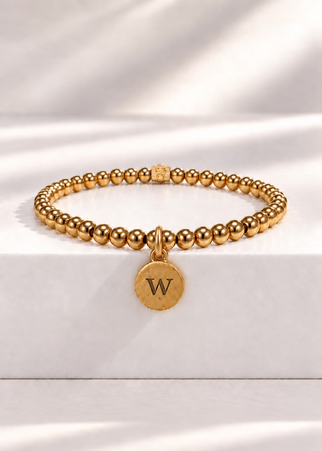 Gold stainless steel beaded bracelet with W initial pendant