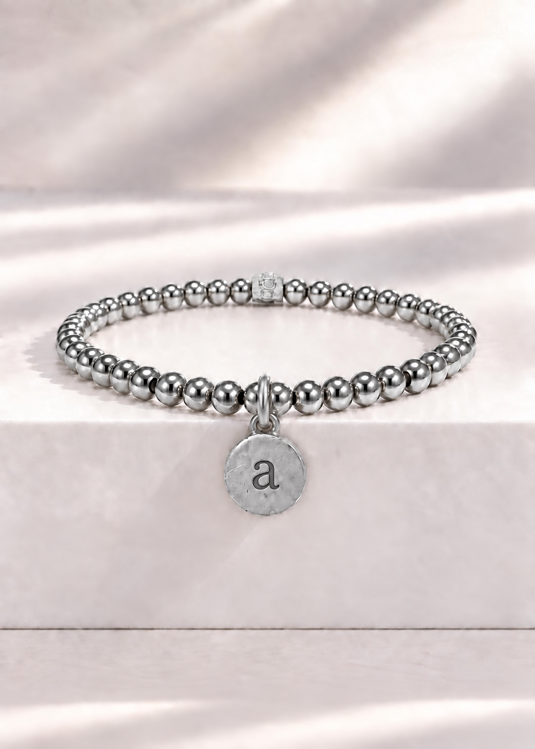 Silver stainless steel beaded bracelet with lowercase a initial pendant