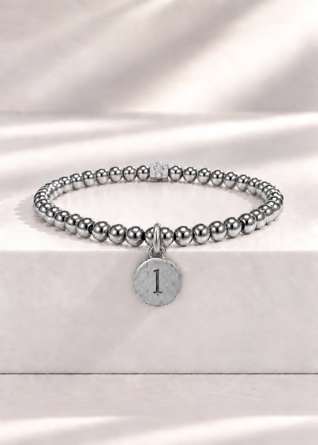 Silver stainless steel beaded bracelet with L initial pendant