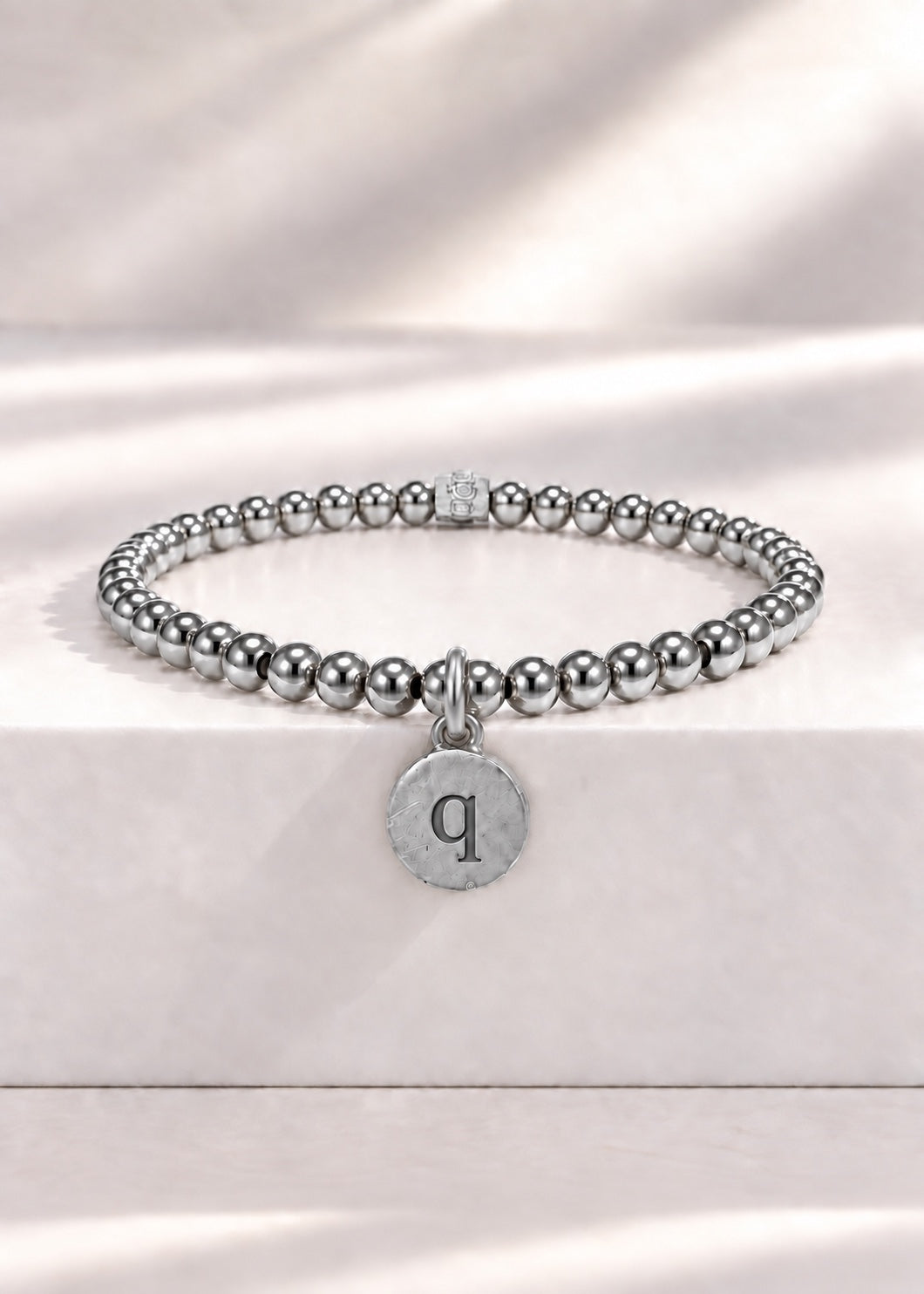 Silver stainless steel beaded bracelet with Q initial pendant